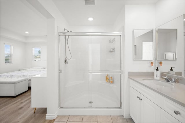 full bathroom with visible vents, a shower stall, recessed lighting, wood finished floors, and vanity