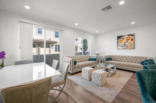 living room featuring visible vents, recessed lighting, and wood finished floors