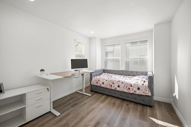 bedroom featuring baseboards and wood finished floors