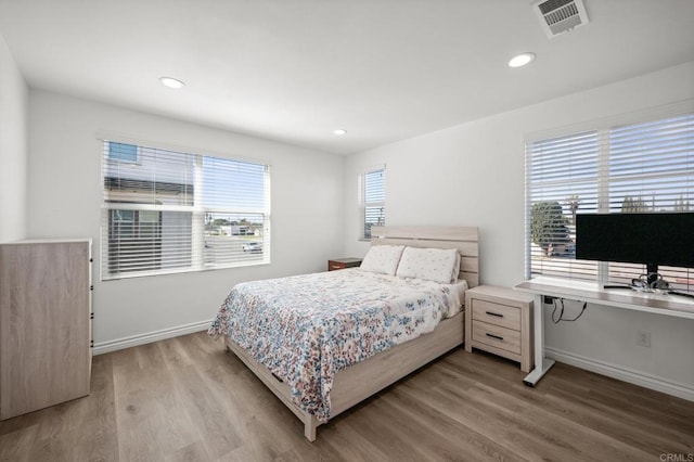 bedroom featuring visible vents, recessed lighting, baseboards, and wood finished floors