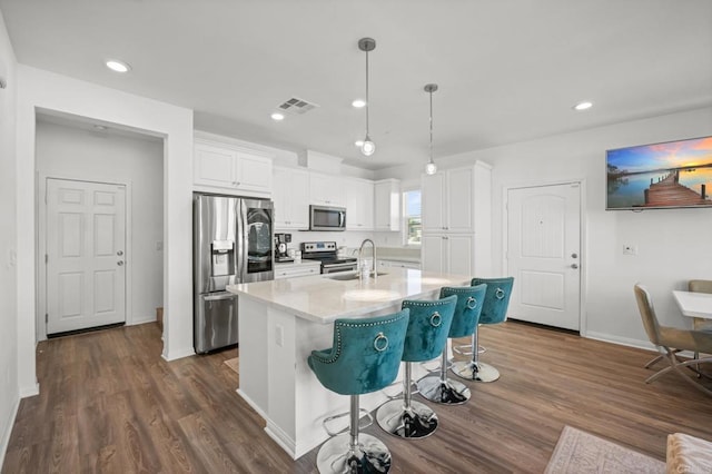 kitchen featuring white cabinetry, dark wood-style floors, visible vents, and stainless steel appliances