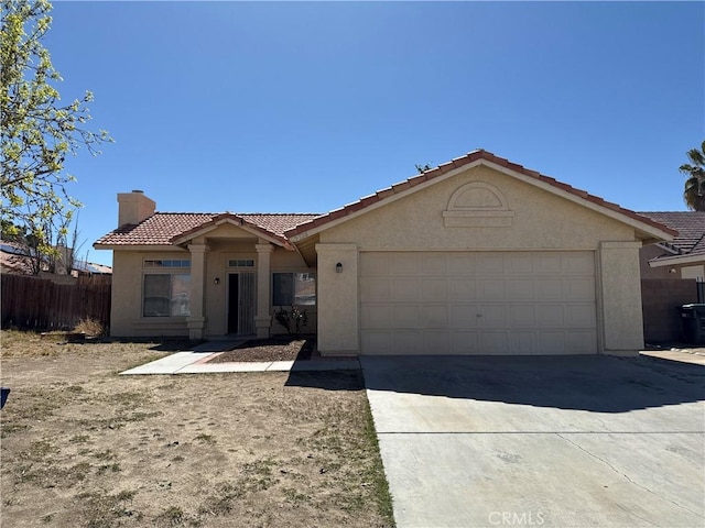 view of front of house with stucco siding, a garage, a chimney, and a tiled roof