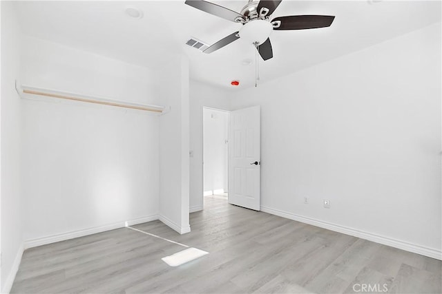 unfurnished bedroom featuring visible vents, baseboards, wood finished floors, and a ceiling fan