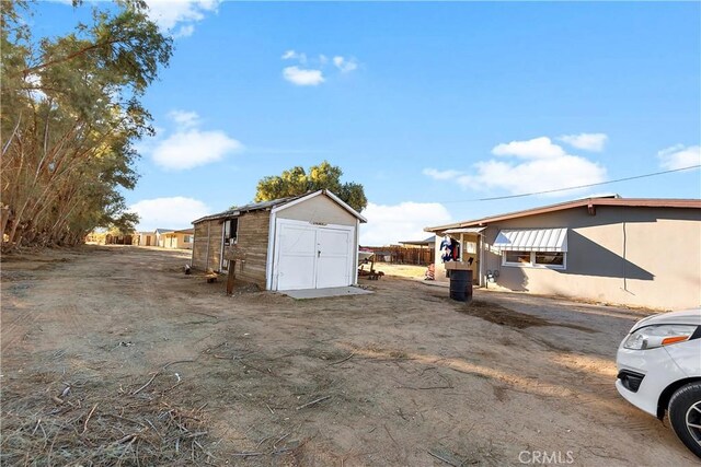 exterior space featuring an outbuilding and a shed