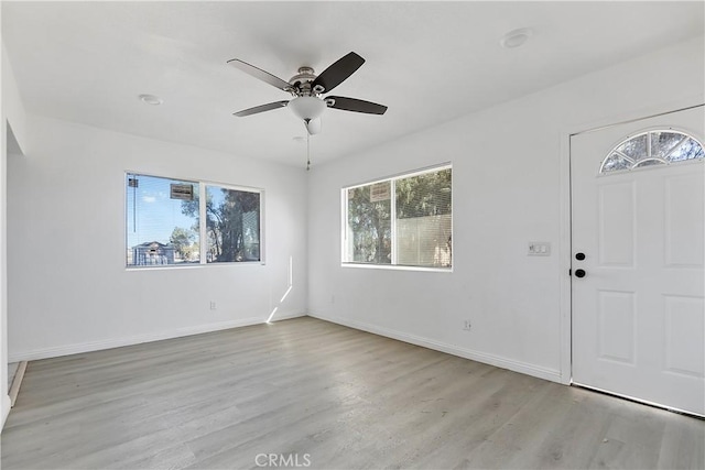 foyer with ceiling fan, baseboards, and light wood-style floors