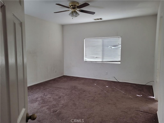 spare room featuring visible vents, carpet, and ceiling fan