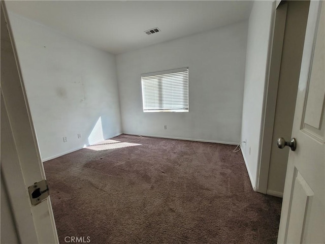 unfurnished bedroom featuring carpet flooring, baseboards, and visible vents