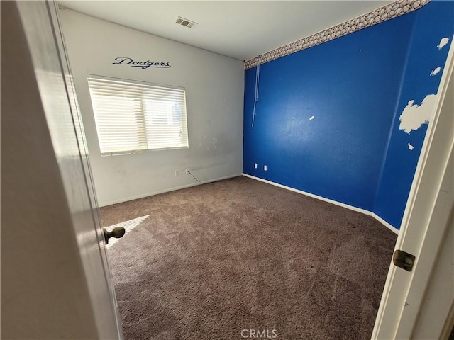 unfurnished bedroom with carpet, visible vents, and baseboards