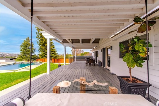 wooden deck featuring a yard, a fenced in pool, and fence