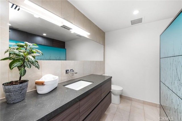 bathroom with vanity, visible vents, tile patterned flooring, toilet, and tasteful backsplash