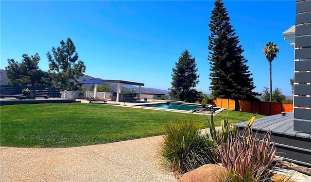 view of yard featuring a fenced in pool, a patio, and fence