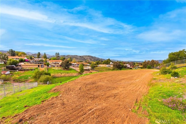 view of community featuring fence and a mountain view