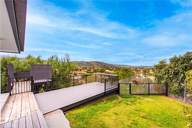 view of yard featuring fence and a mountain view