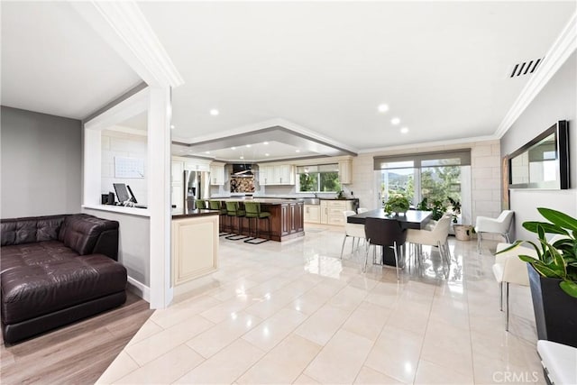 living room featuring recessed lighting, visible vents, ornamental molding, and light tile patterned floors