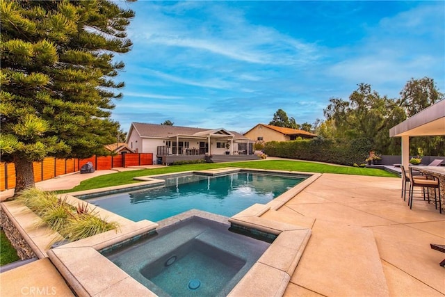 view of swimming pool featuring a patio, a fenced in pool, a wooden deck, an in ground hot tub, and fence private yard