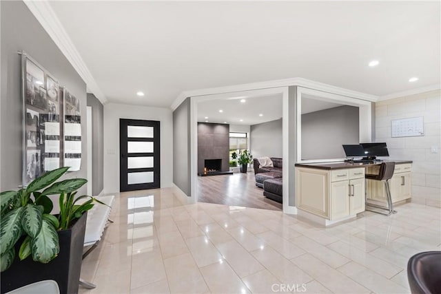 foyer entrance with light tile patterned floors, recessed lighting, a fireplace, and crown molding