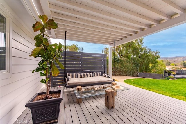 wooden terrace featuring a yard