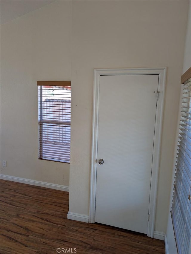 interior space with baseboards and wood finished floors