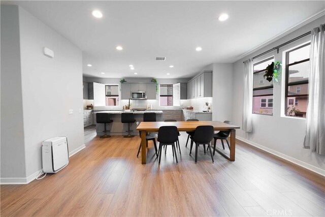 dining space with visible vents, recessed lighting, and light wood-type flooring