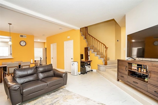 living room with beam ceiling, stairway, baseboards, and visible vents