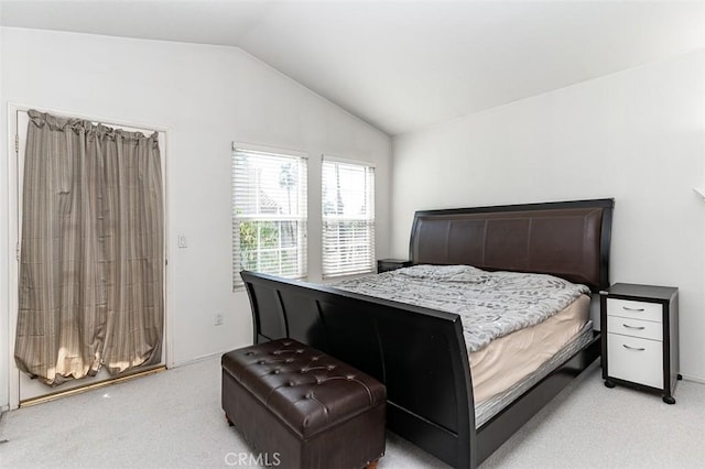 bedroom featuring lofted ceiling and light carpet