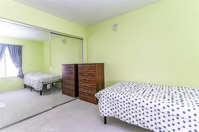 bedroom featuring a closet and carpet flooring