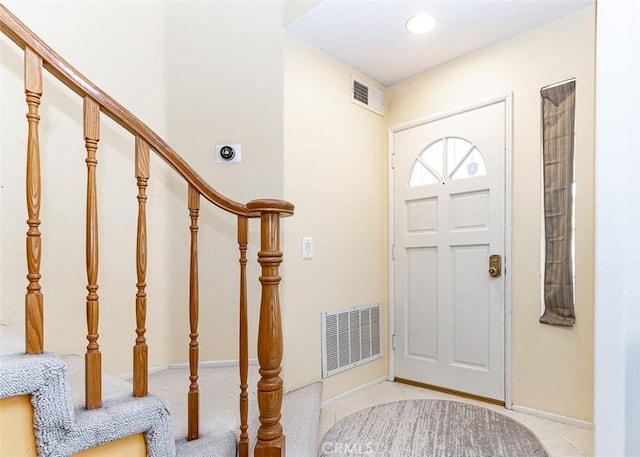 entrance foyer with visible vents, stairs, and baseboards