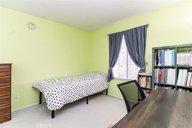 bedroom featuring baseboards and carpet floors