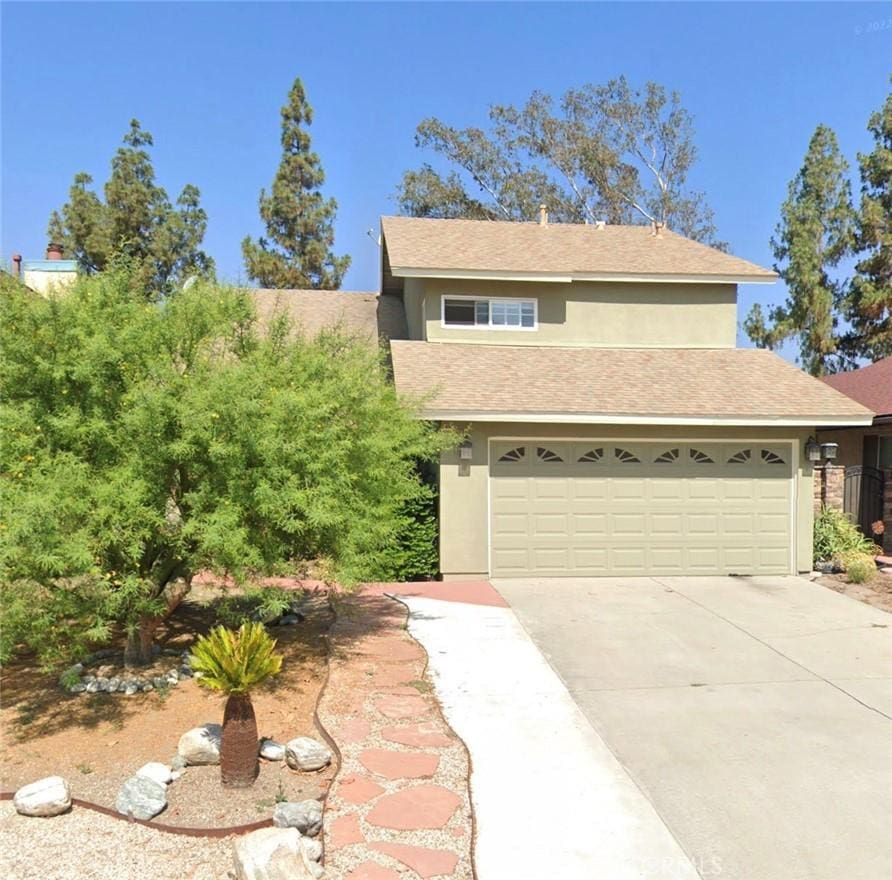 view of front of property with concrete driveway and stucco siding