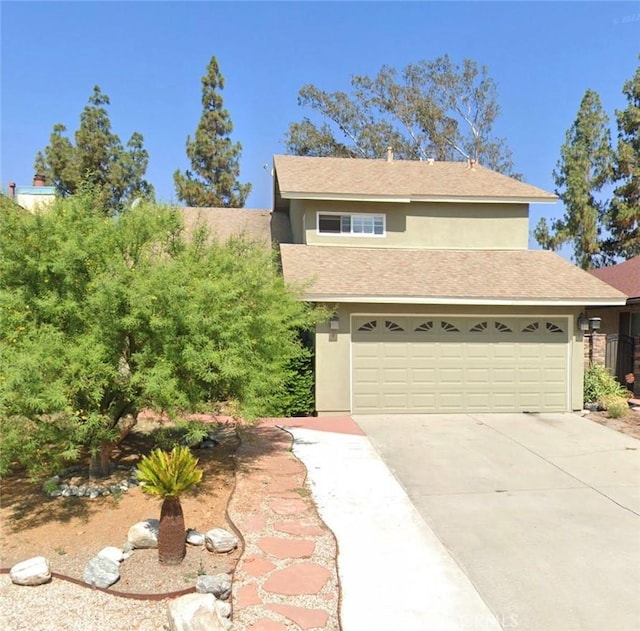 view of front of property with concrete driveway and stucco siding