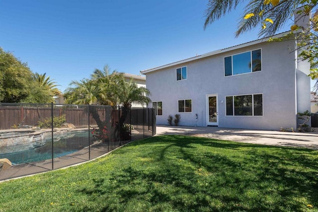 back of property featuring a patio, fence, a fenced in pool, a yard, and stucco siding