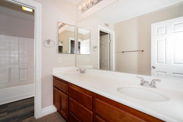 full bath with double vanity, visible vents, and a sink