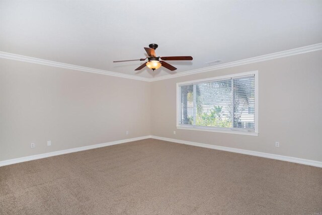 spare room with baseboards, a ceiling fan, and ornamental molding