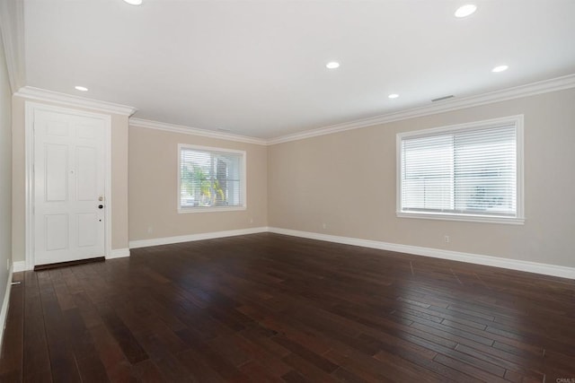 empty room featuring dark wood-style floors, baseboards, visible vents, recessed lighting, and crown molding