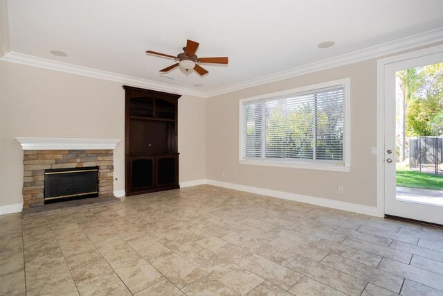 unfurnished living room with baseboards, a wealth of natural light, and ornamental molding