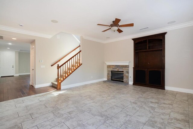 unfurnished living room with stairway, baseboards, visible vents, a fireplace, and crown molding