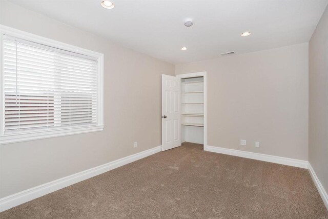 empty room featuring recessed lighting, carpet flooring, visible vents, and baseboards