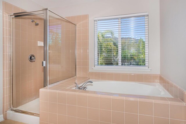 full bath featuring a bath and a shower stall