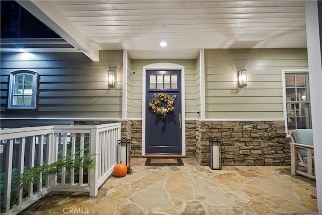 doorway to property featuring stone siding