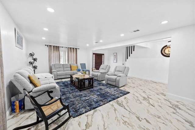 living room with recessed lighting, visible vents, baseboards, and marble finish floor