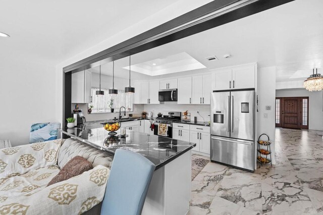 kitchen with white cabinetry, stainless steel appliances, and a sink