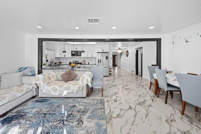 living room featuring recessed lighting, visible vents, marble finish floor, and baseboards