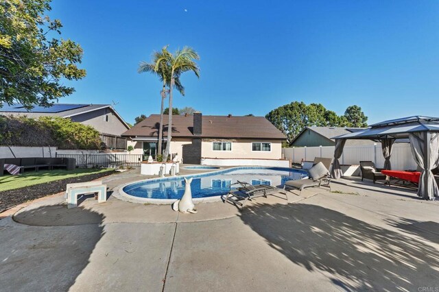 view of swimming pool featuring a gazebo, a fenced in pool, a fenced backyard, and a patio area