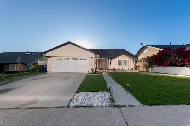 ranch-style house with board and batten siding, an attached garage, a front lawn, and concrete driveway