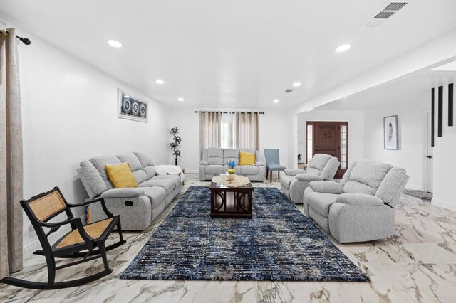 living area with recessed lighting, visible vents, baseboards, and marble finish floor