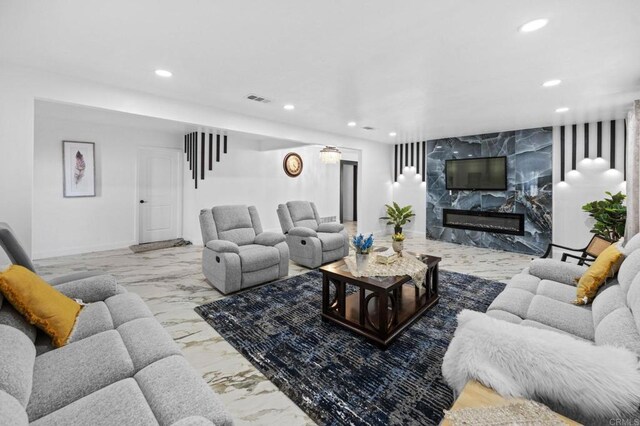 living area with a fireplace, recessed lighting, visible vents, and marble finish floor