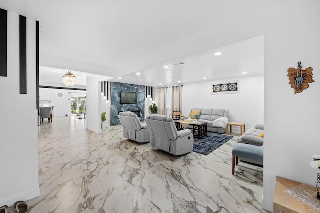 living area with visible vents, baseboards, a chandelier, recessed lighting, and marble finish floor