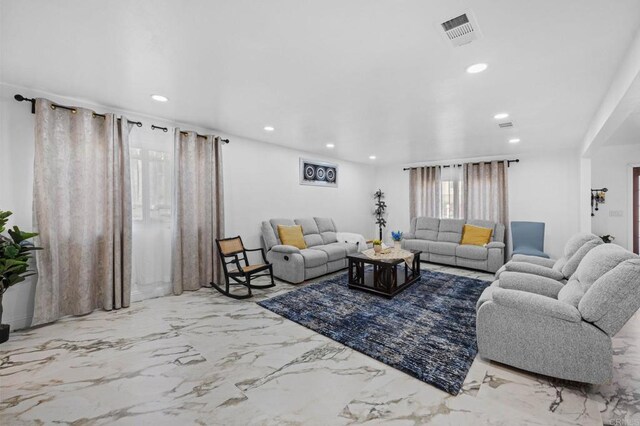 living area featuring recessed lighting, visible vents, and marble finish floor