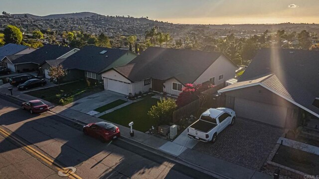 aerial view at dusk with a mountain view and a residential view