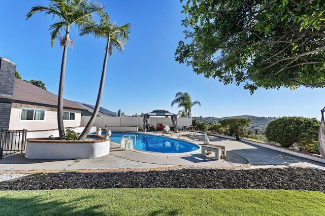 view of pool with a patio, a mountain view, fence private yard, and a fenced in pool